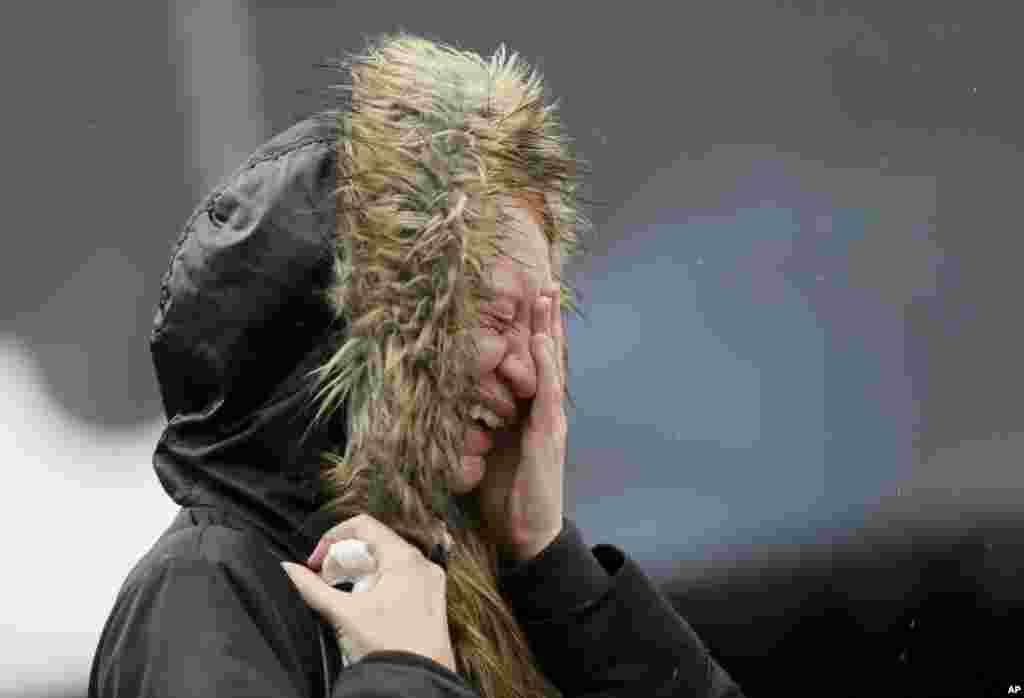 A woman cries at a memorial after a moment of silence to remember the victims of Saturday's attacks in the London Bridge area.
