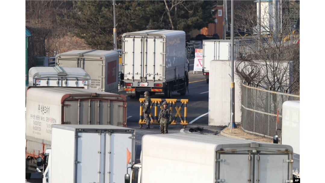 FILE - South Korean cargo trucks head to the North Korean city of Kaesong as South Korean Army soldiers stand guard at the customs, immigration and quarantine office near the border village of Panmunjom in Paju, South Korea, Feb. 11, 2016.