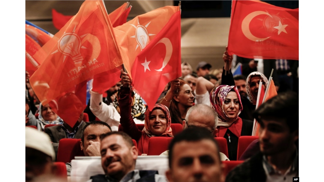 Supporters of Turkey's President and ruling Justice and Development Party leader Recep Tayyip Erdogan wave flags as they listen to him speak during an election rally in Istanbul, Turkey, May 29, 2018.