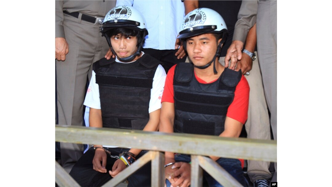 Workers from Myanmar accused of murdering two UK tourists, Saw, left, and Win, sit together during a press conference in Koh Tao island, Surat Thani province, Thailand, Friday, Oct. 3, 2014.