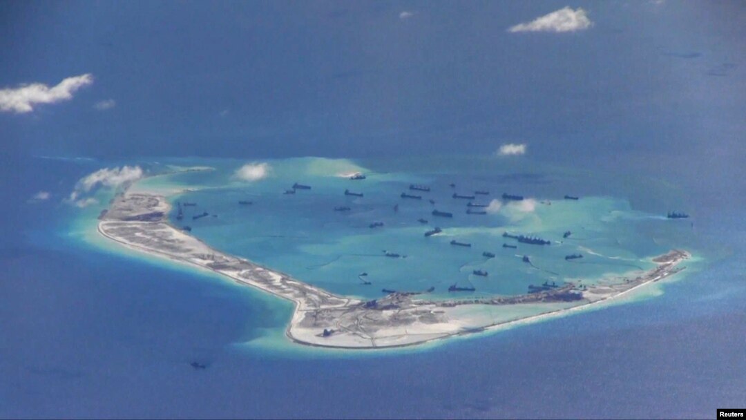Chinese dredging vessels are purportedly seen in the waters around Mischief Reef in the disputed Spratly Islands in the South China Sea in this still image from video taken by a P-8A Poseidon surveillance aircraft provided by the United States Navy, May 21, 2015.