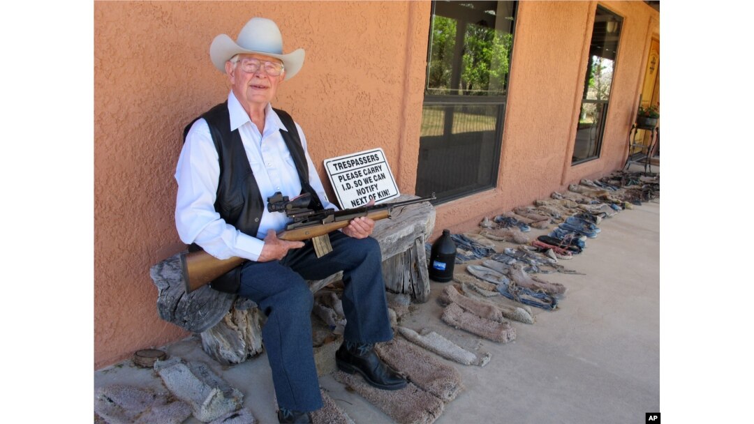 In this Tuesday, March 15, 2016 photo, Jim Chilton poses for a photo on the front porch of his home on his 50,000 acre ranch along the U.S-Mexico border in Arivaca, Arizona.