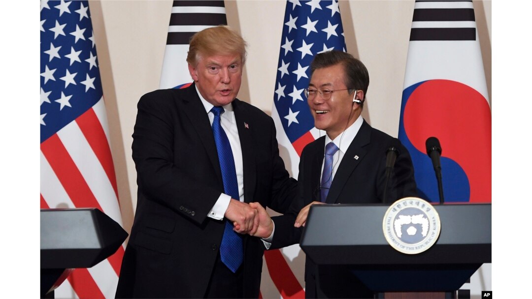FILE - U.S. President Donald Trump, left, and South Korean President Moon Jae-in shake hands during a joint press conference at the presidential Blue House in Seoul, South Korea, Nov. 7, 2017.