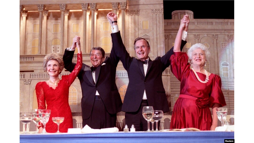 President Ronald Reagan (2nd L) and Vice President George Bush, (2nd R), accompanied by wives Nancy (L) and Barbara, join hands after the President endorses Bushes run for the Presidency