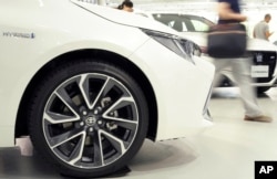 Visitors walk through a Toyota showroom in Tokyo, Aug. 3, 2018. Toyota Motor Corp. has recently enjoyed strong sales in U.S. and other overseas markets.