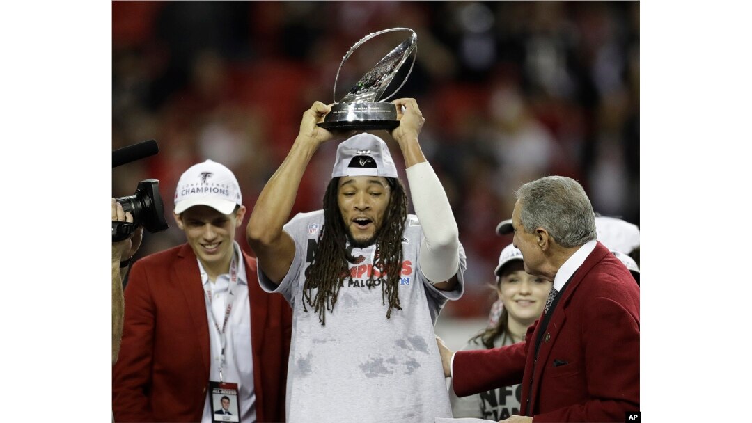 Atlanta Falcons players and owner Arthur Blank celebrate after the NFL football NFC championship game against the Green Bay Packers Sunday, Jan. 22, 2017, in Atlanta. The Falcons won 44-21 to advance to Super Bowl LI.