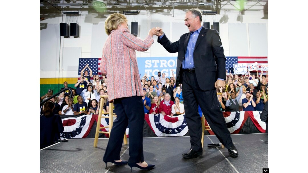 Democratic presidential candidate Hillary Clinton fist bumps Sen. Tim Kaine, D-Va., after speaking at a rally at Northern Virginia Community College in Annandale, Thursday, July 14, 2016.