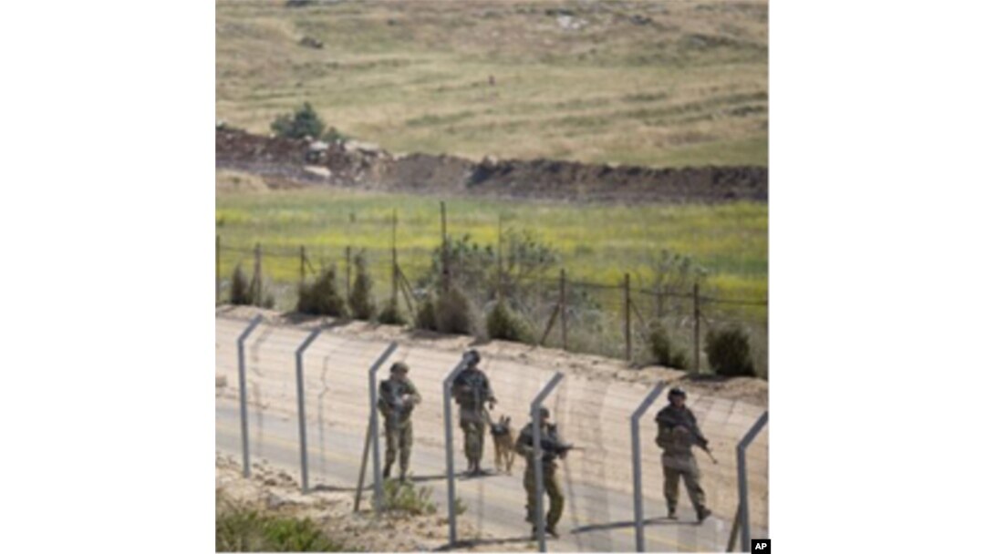 Israeli troops patrol along the border between Israel and Syria near the village of Majdal Shams in the Golan Heights, June 6, 2011