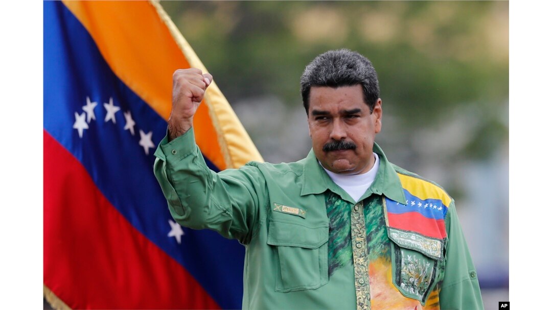 Venezuela's President Nicolas Maduro raises his fist during a closing campaign rally in Caracas, May 17, 2018.