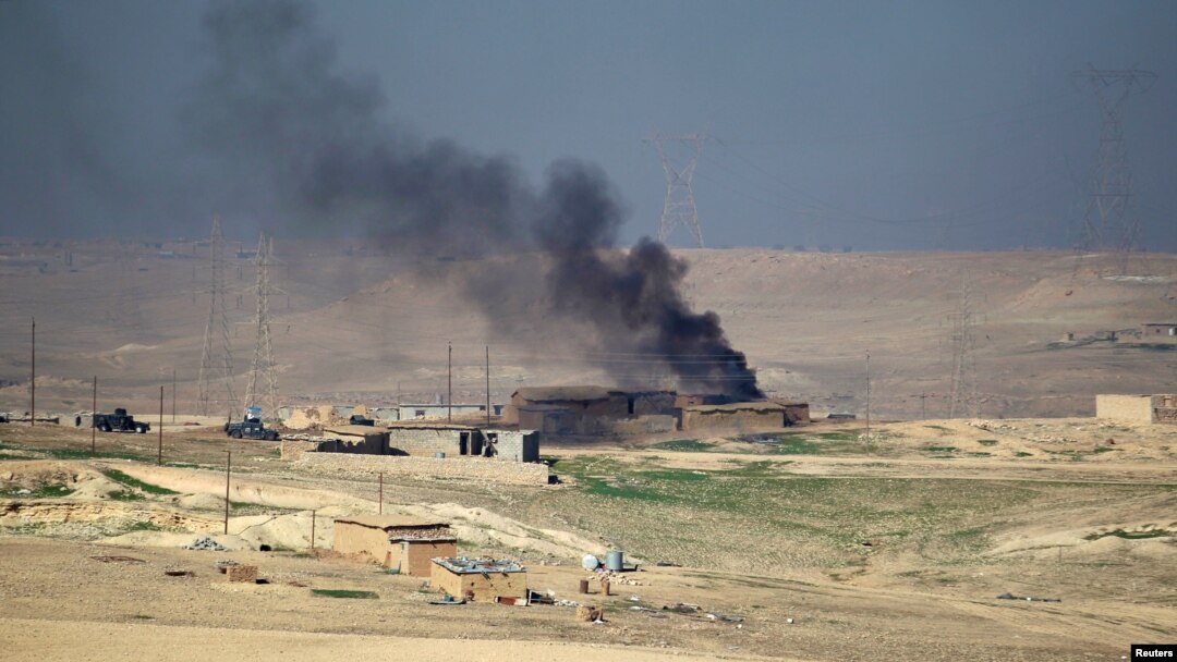 Smoke rises from clashes as Iraqi security forces engage in a battle with Islamic State militants in south of Mosul, Iraq, Feb. 19, 2017.