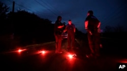 A man talks with officers at a roadblock near the Arkema Inc. chemical plant, Aug. 31, 2017, in Crosby, Texas. The plant that lost power after Harvey engulfed the area was rocked by multiple explosions early Thursday, the plant's operator said.