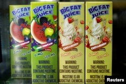 FILE - Packages of flavored liquids for e-cigarettes are seen displayed at a smoke shop in New York City, New York, U.S., May 1, 2018.