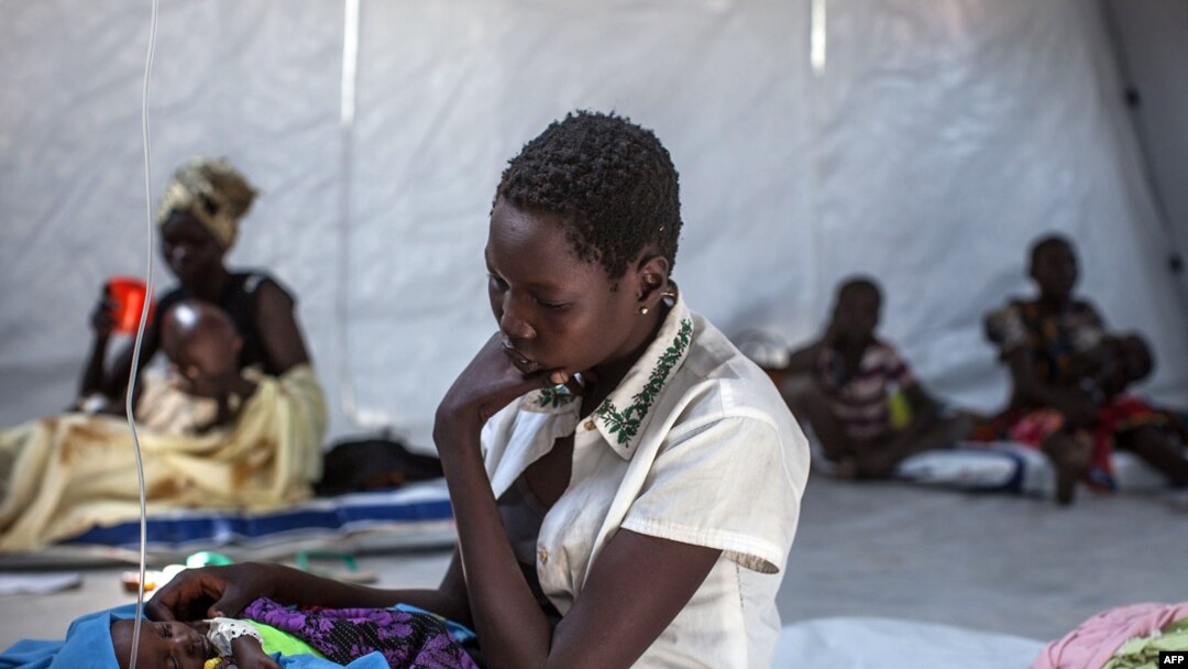 A mother sits with her infant in a clinic run by Doctors Without Borders (MSF) in Minkammen, 25 kilometers (16 miles) south of Bor, Jan. 10, 2014.