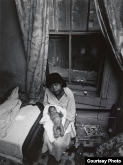Bruce Davidson's photos of an impoverished neighborhood in New York included this gaunt-looking woman with a newborn on her lap.