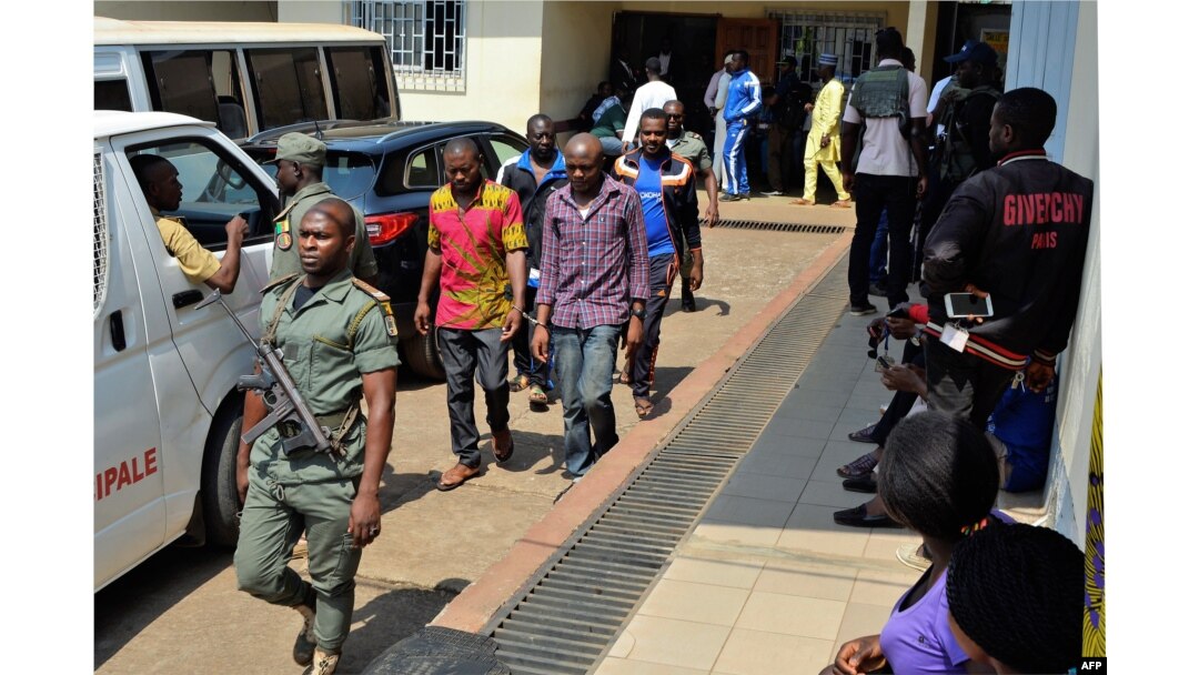FILE - Men arrested in connection with Cameroon's anglophone crisis are seen at the military court in Yaounde, Cameroon, Dec. 14, 2018.