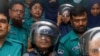 Journalists Shakil Ahmed, fifth from the left, and Farzana Rupa, third from the right, are taken to a court in Dhaka, Bangladesh, on Aug. 22, 2024.