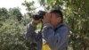 Frank Az, 9, a student at Esperanza Elementary School in Los Angeles, scans an area for bird species. (M. O'Sullivan/VOA)