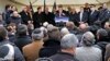 FILE - French Interior Minister Bernard Cazeneuve, center, speaks at a gathering against anti-Semitism also attended by Israel's ambassador to France, Yossi Gal, left, in Creteil, east of Paris, Dec. 7, 2014.