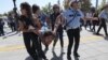 Riot police officers detain a protester during the trial of two Turkish educators, who went on a hunger strike over their dismissal under a government decree following last year's failed coup, outside a courthouse in Ankara, Turkey, Sept. 14, 2017.