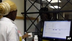 FILE - A patient receives medication from a pharmacist at the Helen Joseph hospital in Johannesburg, South Africa, Nov. 15, 2012.
