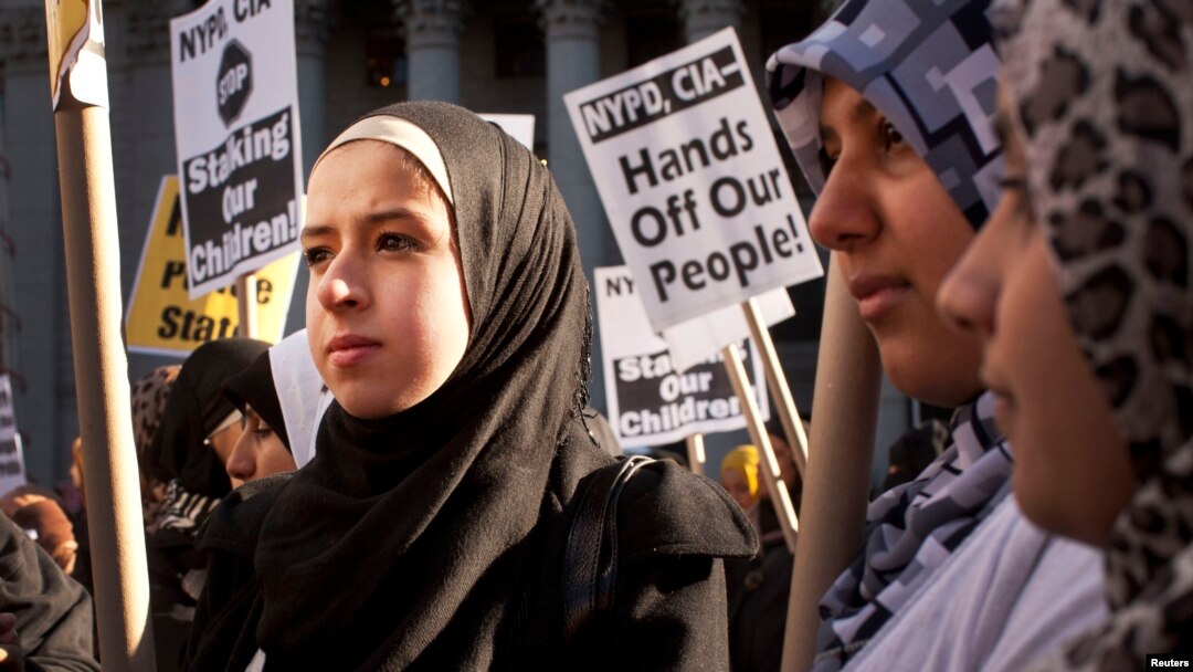 FILE - Muslim women protest against alleged heavy-handedness on the part of the New York Police Department.