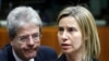 European Union foreign policy chief Federica Mogherini and Italian Foreign Minister Paolo Gentiloni (L) attend a meeting of European Union foreign and defence ministers at the EU Council in Brussels, Belgium, May 18, 2015. 