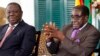 Zimbabwean President Robert Mugabe (R) and Prime Minister Morgan Tsvangirai address a media conference in Harare, January 17, 2013.