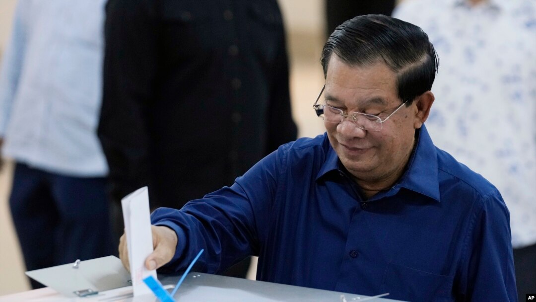 Cambodian Prime Minister Hun Sen of the Cambodian People's Party (CPP) drops a ballot into a box for voting at a polling station at Takhmua in Kandal province, southeast Phnom Penh, Cambodia