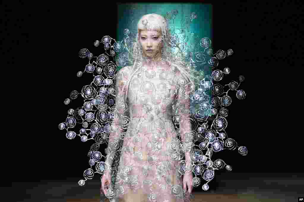 A model wears a creation for Iris Van Herpen's Haute Couture Fall/Winter 2017/2018 fashion collection presented in Paris, France.