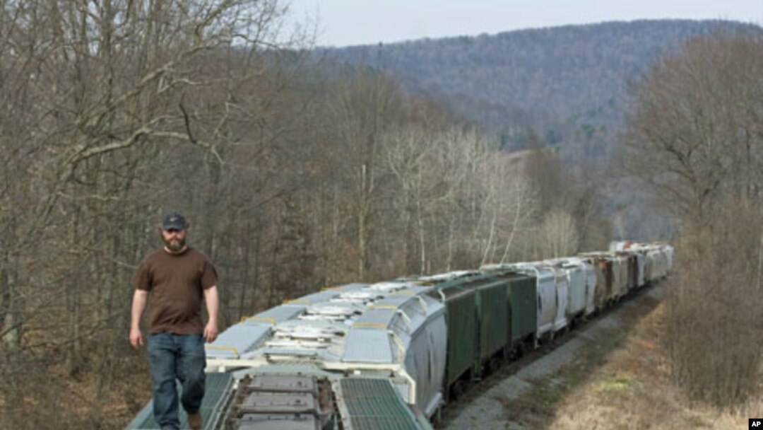 Chief Operating Officer of Wellsboro & Corning Railroad, Bill Myles, examines the end of a 75-car train carrying sand - used in hydraulic fracturing operations - that his company transloads for energy companies drilling natural gas wells in Wellsboro, Pen