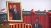 FILE - Participants cheer beneath a large portrait of Chinese President Xi Jinping during a parade to commemorate the 70th anniversary of the founding of Communist China in Beijing, Oct. 1, 2019.