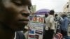 Andrew Owoyemi buys a telephone hand-set at the computer village in Lagos, Nigeria, March 2006.