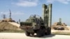 FILE - This photo made from the footage taken from the Russian Defense Ministry official web site on Nov. 27, 2015, shows Russian S-400 air defense missiles being deployed at the Hemeimeem air base in Syria.