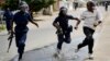 Riot police chase a demonstrator in Bujumbura, Burundi, May 4, 2015.