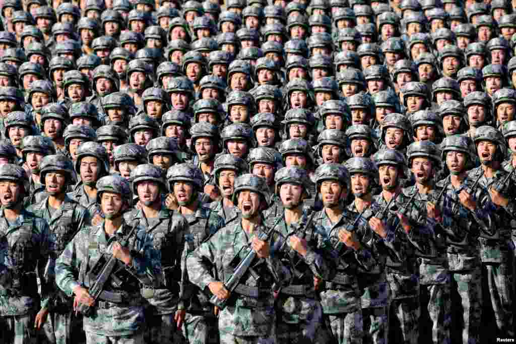 Soldiers of China's People's Liberation Army (PLA) get ready for the military parade to commemorate the 90th anniversary of the foundation of the army at Zhurihe military training base in Inner Mongolia Autonomous Region.