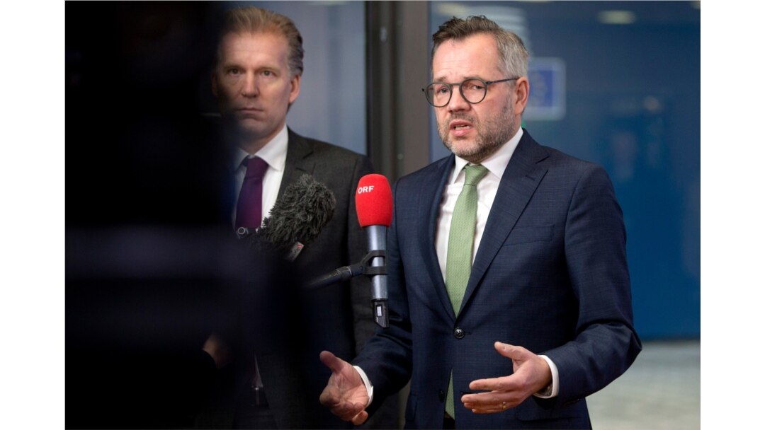 FILE - German Minister of State for European Affairs Michael Roth, right, speaks with the media as he arrives at the Europa building in Brussels, Dec. 11, 2018.