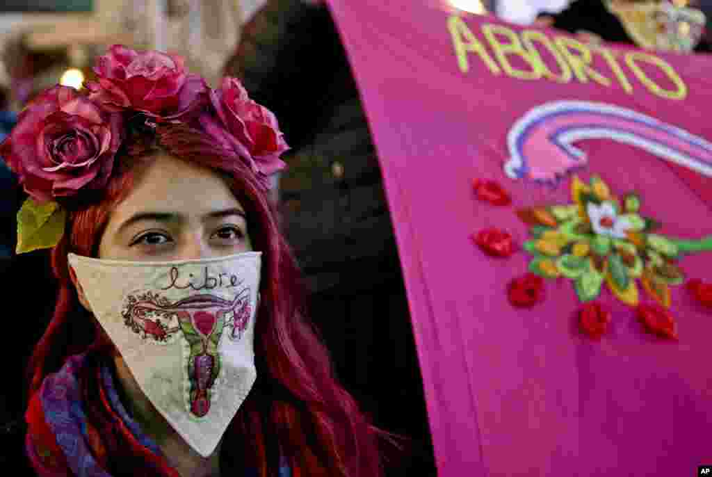 A woman wearing a handkerchief with an embroidered uterus and the Spanish word for "free", takes part in a march in Santiago, Chile, in favor of a bill backed by President Michelle Bachelet, to legalize abortions in three situations: when the mother's life is in danger, when the fetus is not viable, and in cases of rape, July 25, 2017.