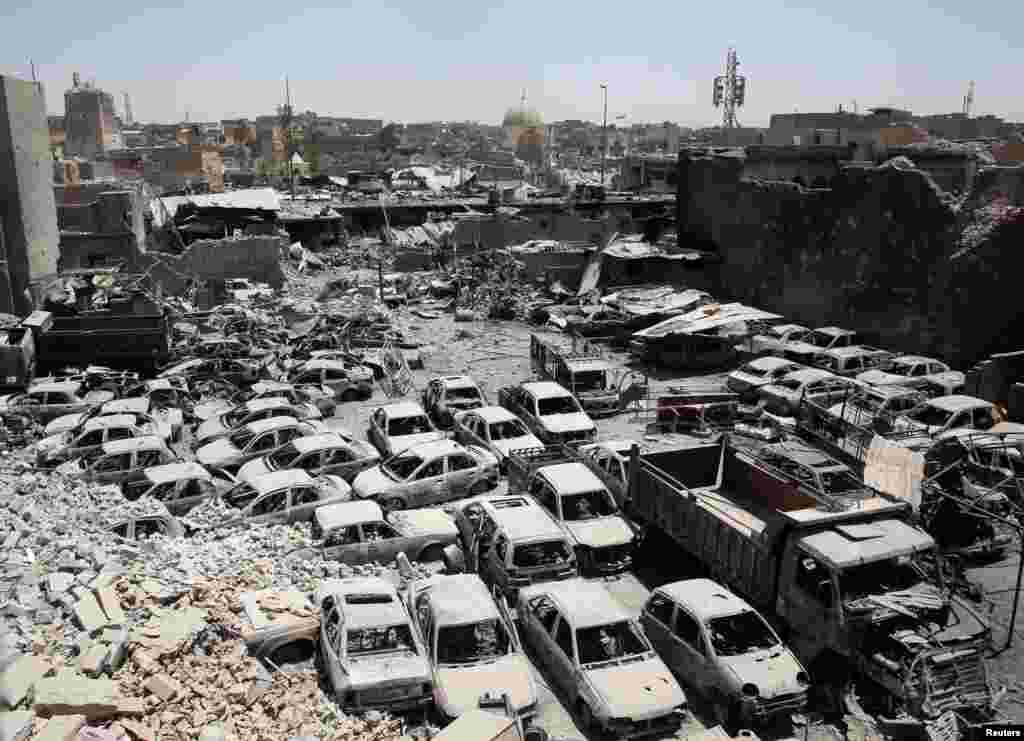 A destroyed al-Hadba minaret at Grand al-Nuri Mosque (L) is seen in Mosul, Iraq.