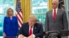President Donald Trump signs an executive order to keep families together at the border, but says that the 'zero-tolerance' prosecution policy will continue, during an event in the Oval Office of the White House in Washington.