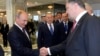 Russian President Vladimir Putin (L) shakes hands with his Ukrainian counterpart Petro Poroshenko at the start of talks in Minsk, Belarus, Aug. 26, 2014.