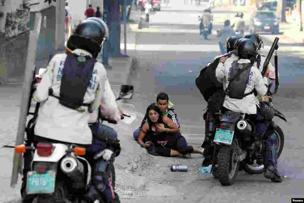 Opposition supporters affected by tear gas reacts during a rally against Venezuelan President Nicolas Maduro's government in Caracas, July 9, 2017.