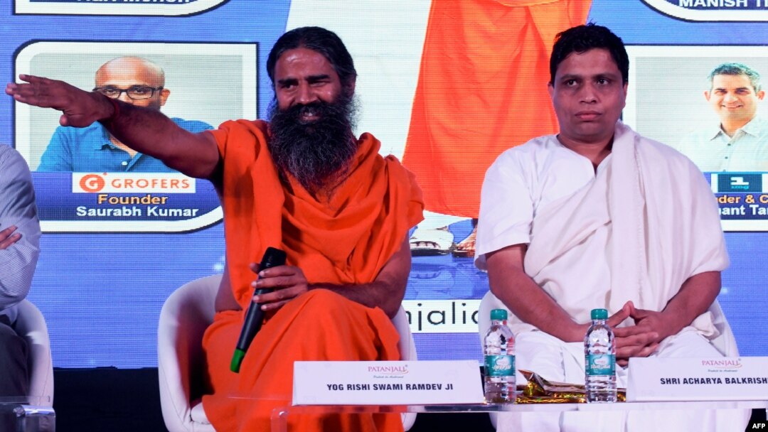 Indian guru Baba Ramdev (L) and Patanjali Ayurveda Managing Director Acharya Balkrishna, are seen during a press conference in New Delhi, India, Jan. 16, 2018.