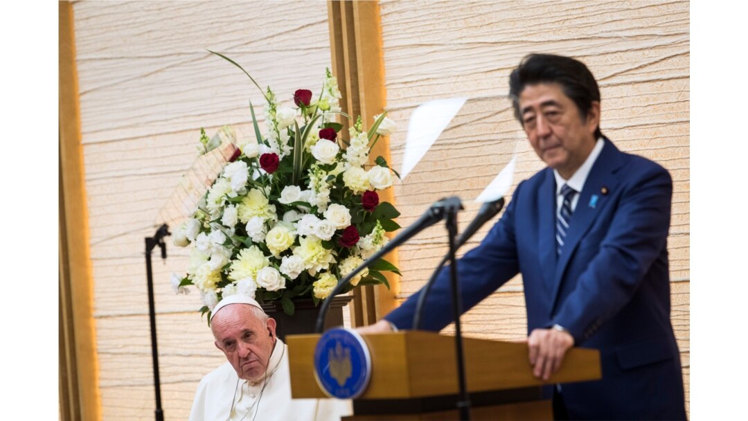 Japan's Prime Minister Shinzo Abe, right, delivers a speech as Pope Francis listens in Tokyo, Nov. 25, 2019.