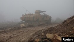 A Turkish military tank is seen near Mount Barsaya, northeast of Afrin, Syria, Jan. 23, 2018. 