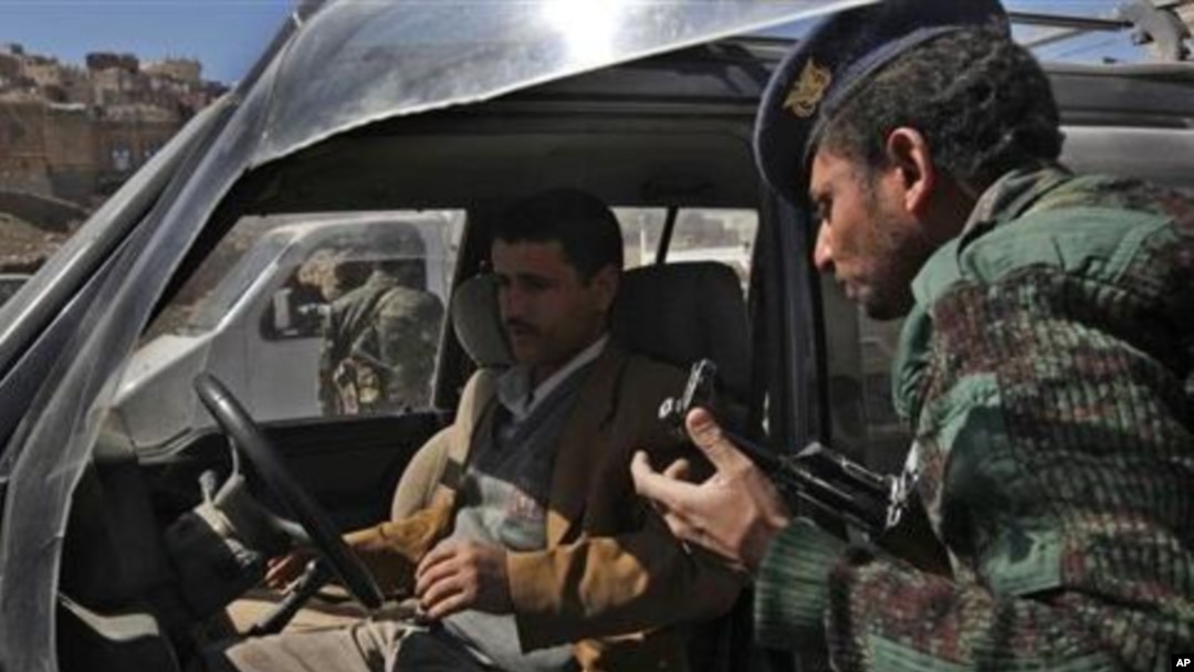 A soldier and citizen at a security checkpoint in Yemen, one of the countries the study's authors believe should be urged to institute more democratic reforms.