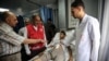 FILE - Francesco Rocca (2nd-L), the President of the International Federation of Red Cross and Red Crescent Societies, meets a Palestinian receiving treatment for wounds sustained during protests at the Gaza-Israel border, during his tour of the Red Crescent Hospital in Khan Yunis in the southern Gaza Strip, May 22, 2018.