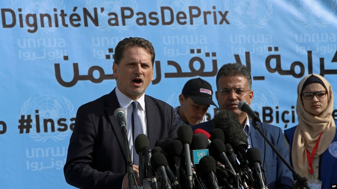 FILE - UNRWA’s commissioner-general, Pierre Kraehenbuehl, left, gives a press conference to launch a global campaign to support UNRWA, at the UNRWA Rimal Girls Preparatory School in Gaza City, Jan. 22, 2018.
