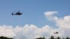 FILE - AH-64 Apache helicopters fly during a live-fire drill of the U.S. Army's 1st Armored Brigade Combat Team, 1st Armored Division at the Rodriguez Live Fire Complex, in Pocheon, South Korea, Aug. 14, 2024.