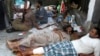 Wounded supporters of deposed Egyptian president Mohamed Mursi wait for treatment at a field hospital in Cairo, July 8, 2013. 