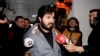 FILE - Turkish-Iranian businessman Reza Zarrab, charged in the U.S. with allegedly evading sanctions on Iran, is surrounded by reporters as he arrives at a courthouse in Istanbul, in a separate case against him, Dec. 17, 2013.